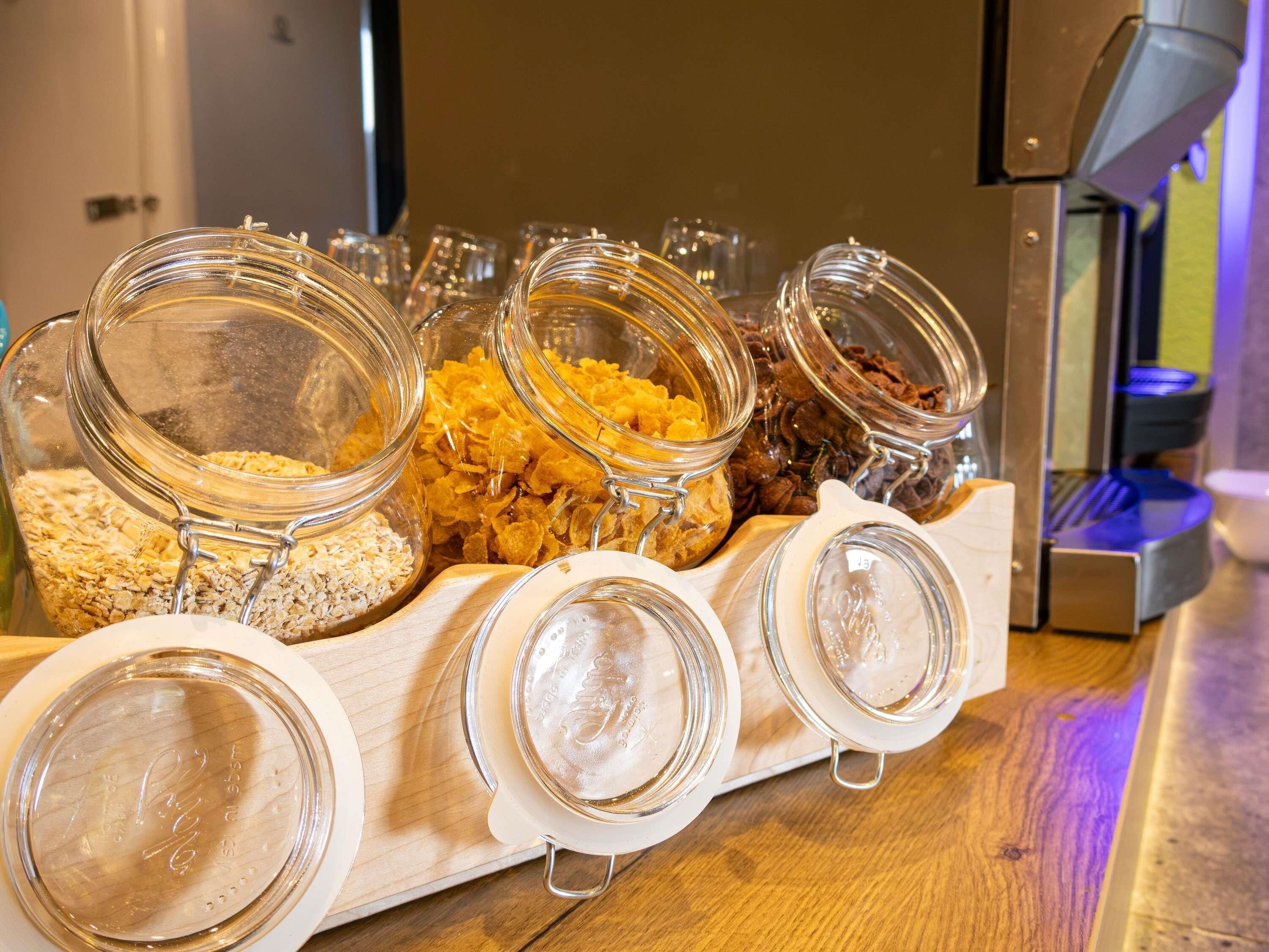 A food display with various jars containing different food items.
