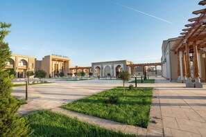 A hotel with a courtyard, arched entrances, and a pergola. - Mercure Khiva (Khiva)