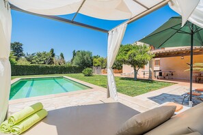 A poolside area with a covered seating area, a pool, and a view of the surrounding landscape. - Private Pool Villa in Pollensa (Pollença)