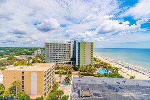 A hotel with multiple buildings, a beach, and a pool area. - The Oceanview | Sea Mist Fifty-One Twenty Oh Two (Myrtle Beach)