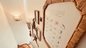 A staircase with a wall-mounted display featuring marine life illustrations and a framed text. - Villa, sea view, 14 guests (Le Lavandou)