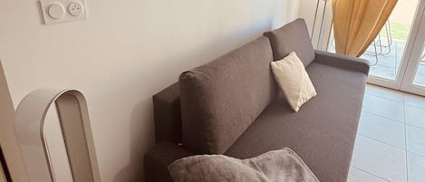A modern living room with a sofa, a coffee table, and a lamp.