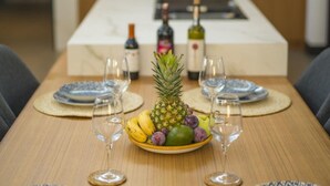 A dining table set with plates, cutlery, and a fruit centerpiece. - Wonderful 2-bedroom house with AC in charming Fethiye (fethiye)