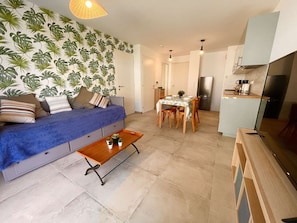 A compact living space with a sofa, dining table, and kitchenette. - Apartment, air conditioning, parking - 4 guests (Le Lavandou)