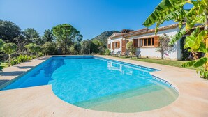 A rectangular swimming pool with clear blue water, surrounded by a concrete deck. - Contemporary Mallorcan Villa for 6 (Pollença)
