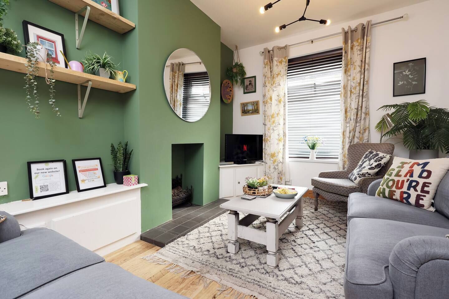 A living room with a fireplace, a television, and a sofa.