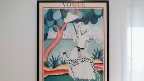 A framed vintage Vogue magazine cover on a wall above a wooden desk with a chair. - 9 Anne St Diamond Cr (Diamond Creek)