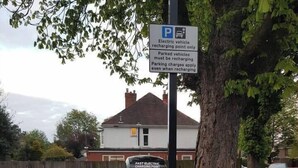 A parking sign and a charging station for electric vehicles. - #07 Edwardian Terrace in Royal Sutton NEC BHX (Birmingham)