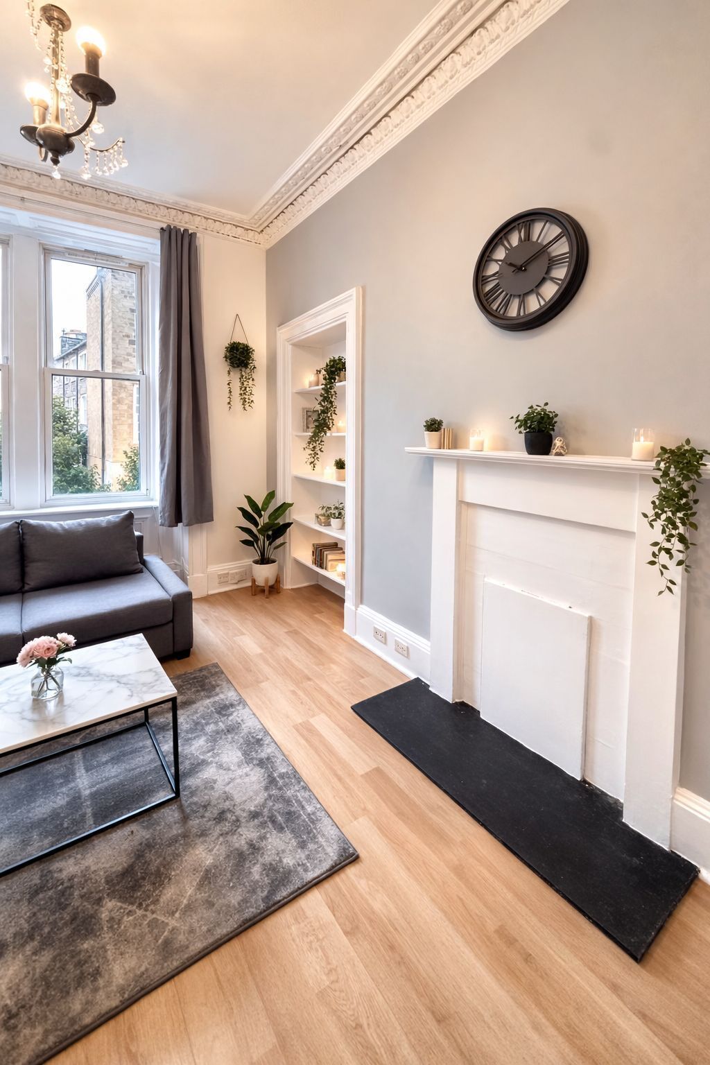 A modern living room with a fireplace, a sofa, a coffee table, and a bookshelf.
