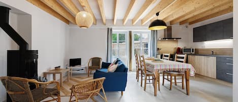 A modern interior with a dining area, kitchen, and living space.