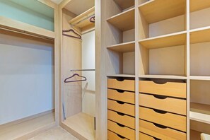 A walk-in closet with wooden shelving and drawers. - #110 Charming Country Stay at Brook Farm, Somerset (Whatley)