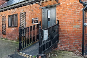A brick building with a sign reading 'The Cottage.'