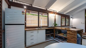 A modern kitchen with a built-in oven, a microwave, and a sink.