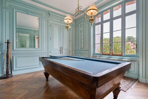 A pool table in a room with light blue walls and a large window. - Holiday Home 'Grande Villa Italienne Avec Parc' with Private Pool, Private Terrace and Wi-Fi (Saint-Étienne-de-Mer-Morte)