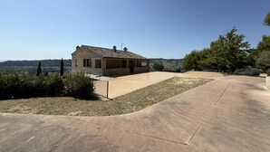 A single-story stone building with a flat roof, a paved patio, and a view of the countryside. - SNB002 - Pedaso, stunning portion of a villa with a swimming pool (Altidona)