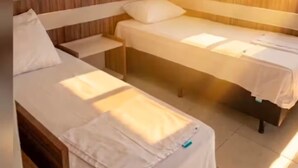 A hotel room with two single beds, a wooden headboard, and a tiled floor. - L'acqua di Roma III - 2 Premium Suites / Sleeps 4 (Caldas Novas)