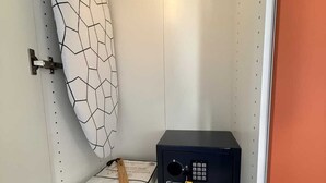 A bathroom with a shower curtain, a towel, and a black electronic device on a shelf. - Les Terrasses Sainte Odile - City center - AC - Private parking - Train Station (Obernai)