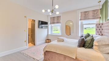 A bedroom with a bed, a mirror, a window, and a door.
