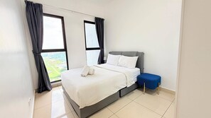 A modern bedroom with a bed, a nightstand, a blue bench, and large windows with curtains. - Trion KL Residence Pearl Suites (Kuala Lumpur)
