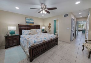 A bedroom with a bed, nightstands, a ceiling fan, and a view to the outside. - Steps to Sapphire's Sandy Beach - D12 Crystal Cove - Sapphire Bay West (St Thomas)
