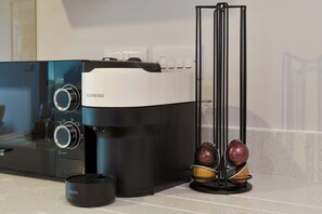 A coffee maker with a timer and power settings, a Krups coffee pot, and a coffee grinder on a kitchen counter. - Luxury 1-Apt Old Trafford King Bed (Manchester)