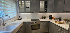 A modern kitchen with stainless steel appliances, a built-in oven, and a coffee maker. - 
Exclusive semi-detached house, at short distance from the beach and local shops (Calahonda)