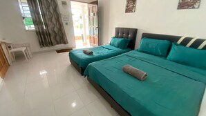 A hotel room with two beds, a small table, and a view of the outside. - Hotel O Panggas Village Homestay (Kangar)