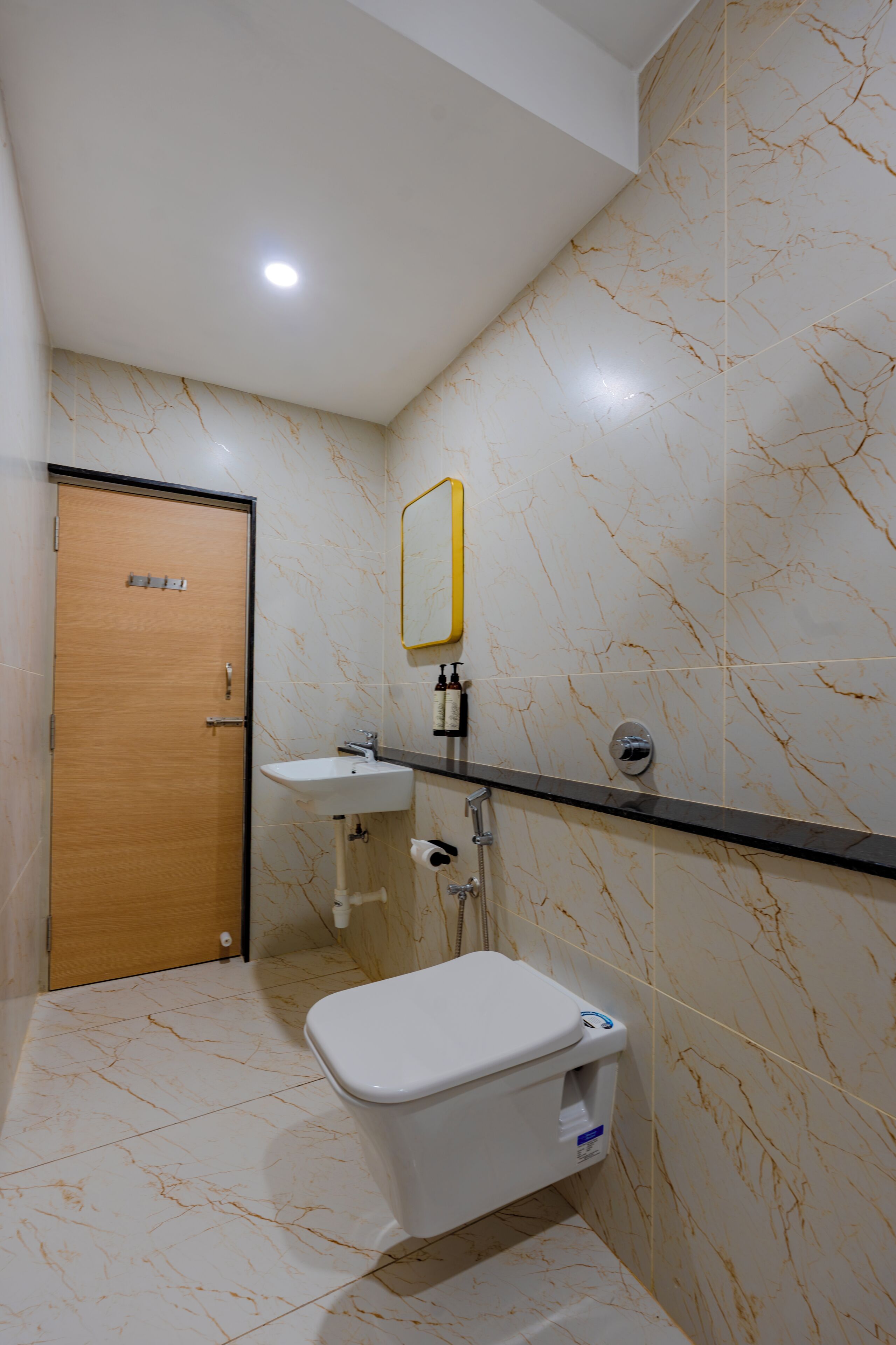 A bathroom with a toilet, sink, and shower.