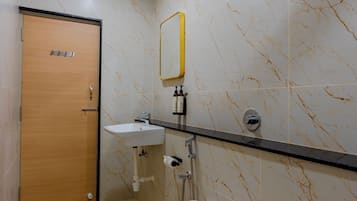 A bathroom with a toilet, sink, and shower.