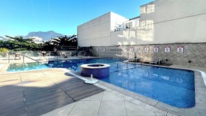 A swimming pool with a hot tub, lounge chairs, and a view of mountains. - Apartment in Leblon, Rio de Janeiro!
Best neighborhood, 2 blocks from the beach. (Rio de Janeiro)