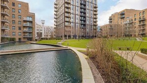 A residential building complex with multiple floors, a central courtyard with a water feature, and a well-maintained lawn. - Student Only Clay Wembley (Wembley)