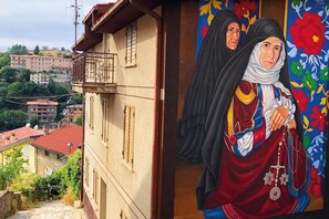 Ein Gebäude mit Balkon, Satellitenschüssel und Blick auf die Umgebung.