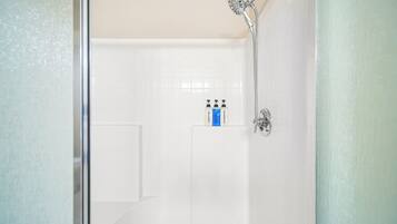 A bathroom with a shower, a toilet, and a sink.
