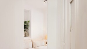 A hallway leading to a living area with a sofa and a lamp. - Your Lisbon Home Santa Apolónia (Lisbon)