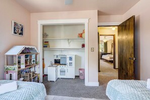 A child's playroom with a dollhouse, shelves with toys, and a kitchenette. - Suncrest Rise! Family Escape Near Fort Carson (Colorado Springs)