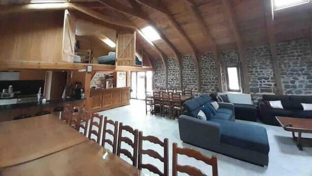 An interior with a dining area, sofas, and a kitchen. - Charlie's house. (Le Monastier-sur-Gazeille)