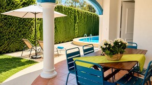 A patio area with a pool, outdoor seating, and a potted plant. - Villa Molins Aries - Three Bedroom Villa, Sleeps 6 (Les Marines)