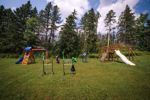 A playground with various play structures including slides and climbing frames.
