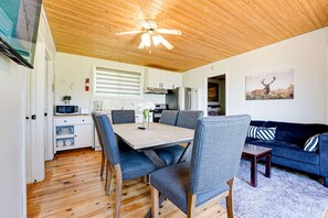A modern interior with a dining area, kitchen, and living space.