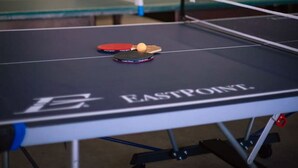 A ping pong table with a ball and paddle, a second table in the background, and a tent-like structure. - Beachfront Cabin #5- Maijac Resort & Marina (Burk`s Falls)