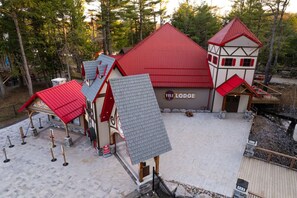 A lodge with a red roof, a ticket booth, and a sign that reads 'Yule Lodge.'