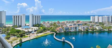 A coastal resort with a marina, buildings, and a clear view of the ocean.