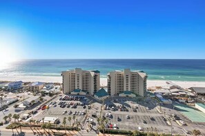 A coastal hotel with multiple buildings, a parking lot, and a beach in the background. - 🏖️Gulf Views-5 Pools-Laketown Wharf 1817🏖️ (Panama City Beach)