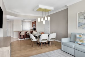A modern living room with a dining area, a sofa, and a kitchen in the background. - Dream Florida Escape in Fort Lauderdale! (Fort Lauderdale)