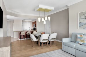 A modern living room with a dining area, a sofa, and a kitchen in the background. - Dream Florida Escape in Fort Lauderdale! (Fort Lauderdale)