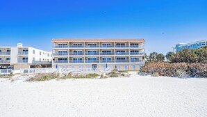 A multi-story hotel with balconies, located on a sandy beach. - Oceanside 205-Private Balcony Sunsets (Indian Rocks Beach)