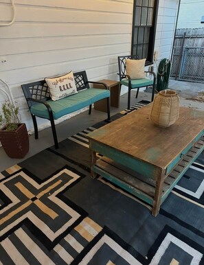 A room with a wooden table, two chairs, a patterned rug, and a potted plant. - Walk to Dickies&Will Rogers|Guest Suite+Game Room (Fort Worth)