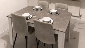 A dining table set with plates, glasses, and cutlery.