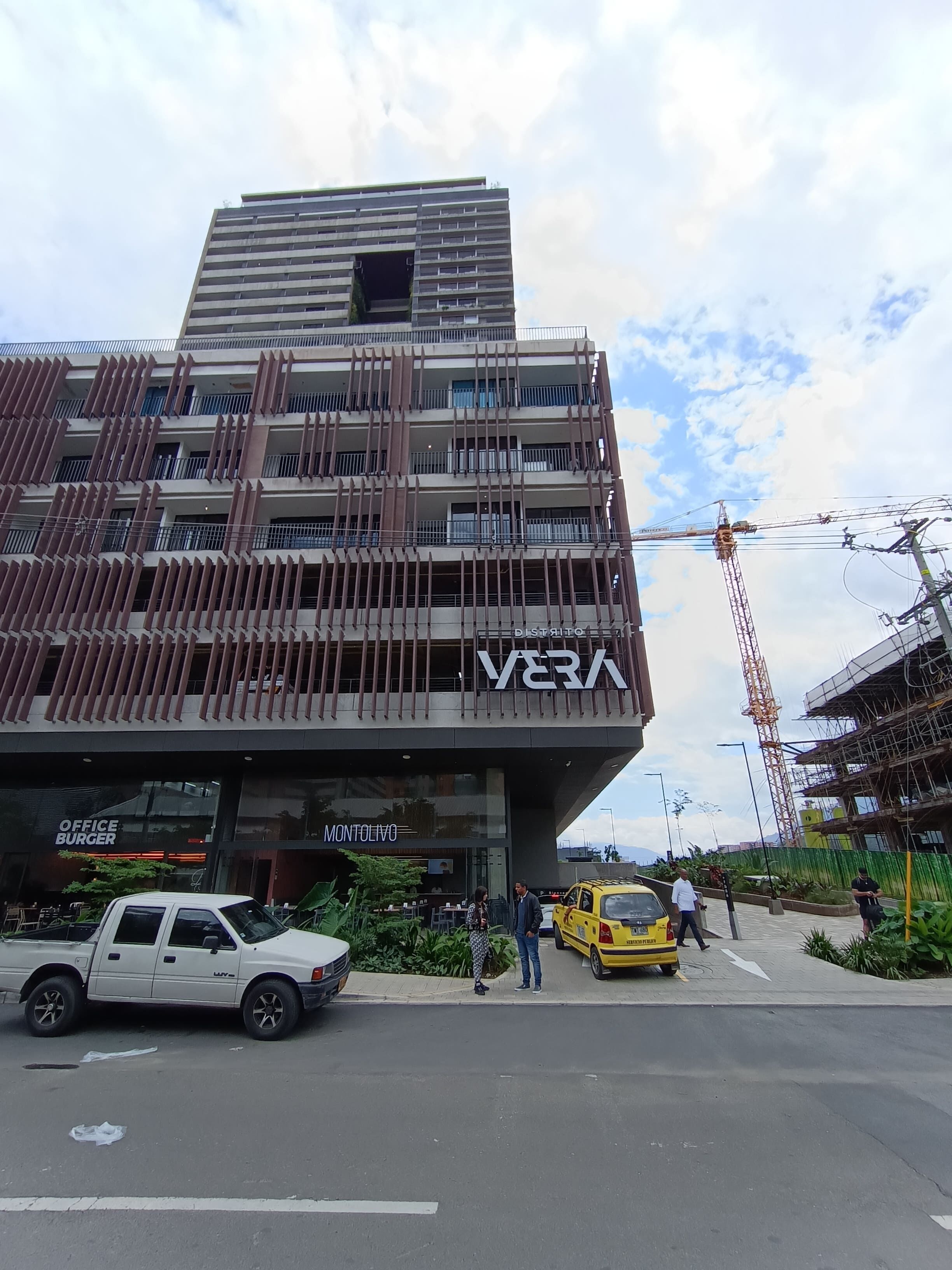 A multi-story building with a modern design, featuring a prominent 'Vera' sign.