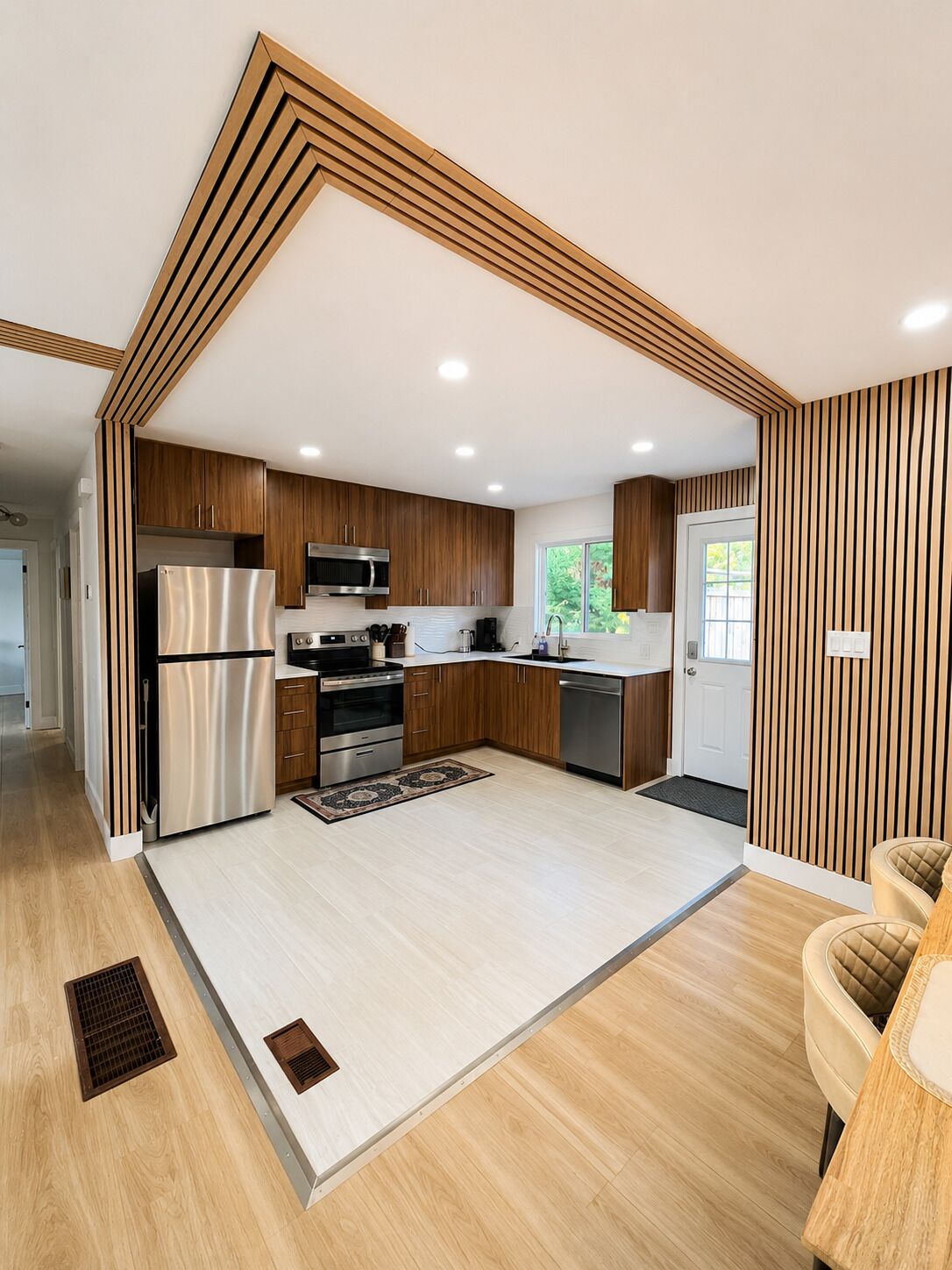 A modern kitchen with wooden cabinetry, stainless steel appliances, and a central island.